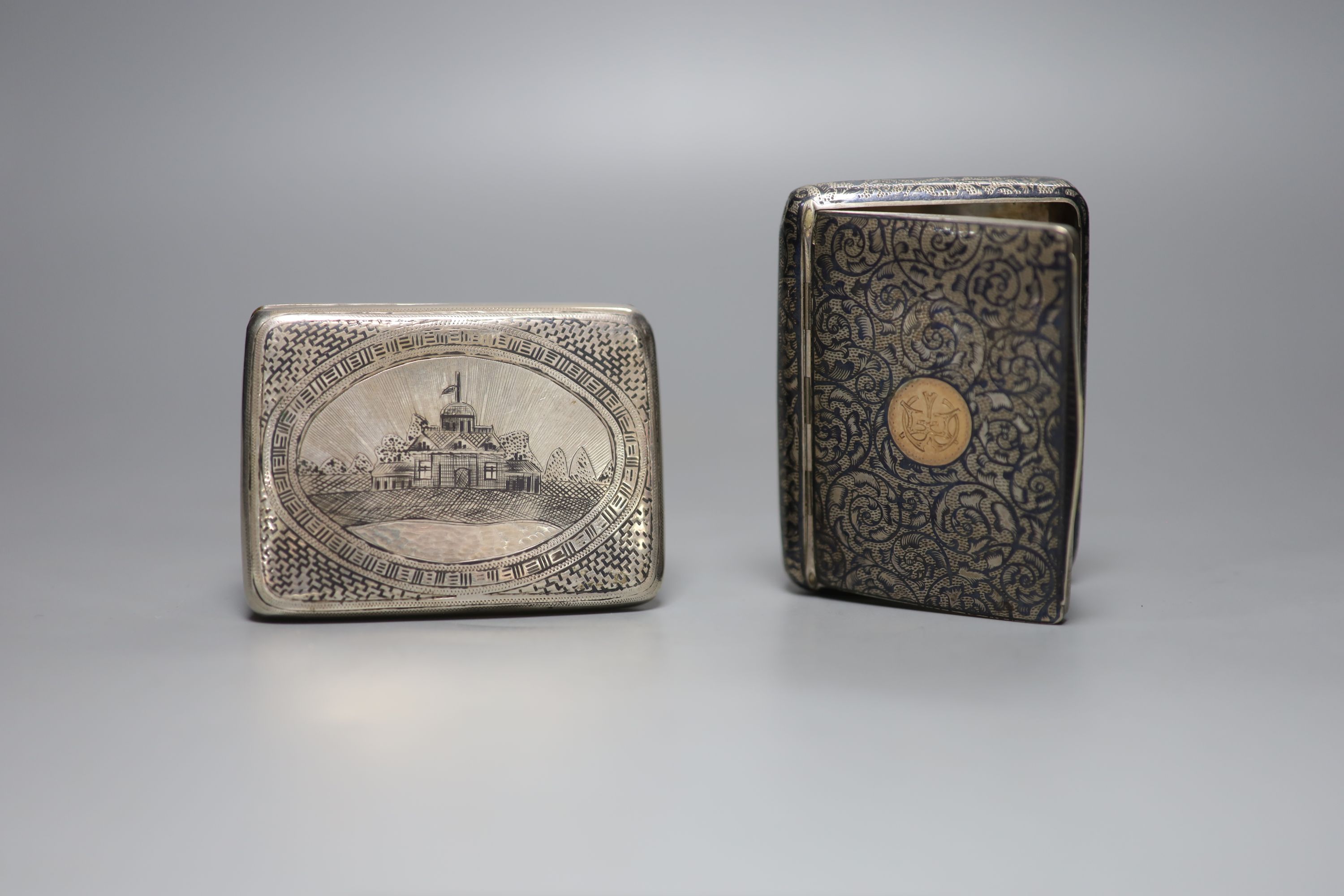 A late 19th century Russian 84 zolotnik and niello cigarette case, 89mm and an Austro-Hungarian 900 standard white metal and niello cigarette case, gross 7oz.